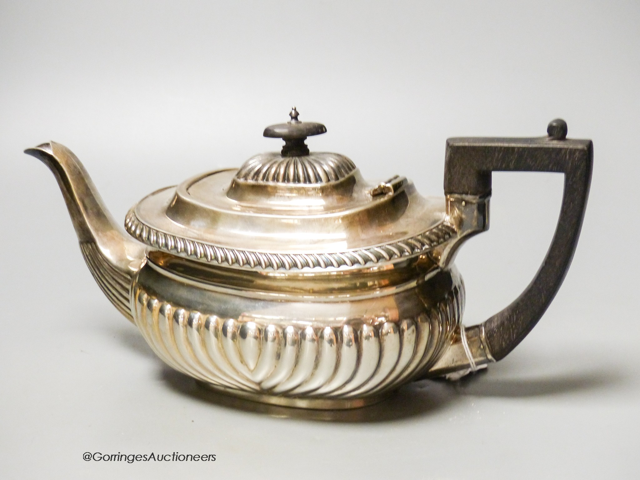 A Mappin & Webb fluted silver teapot, Sheffield, (marks rubbed) presented to ‘Sister Job, From Her Friends at Guy’s Hospital, 1898, gross 23 oz.